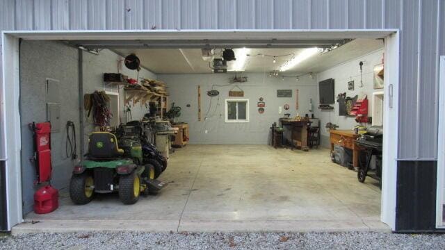 garage with electric panel and a garage door opener