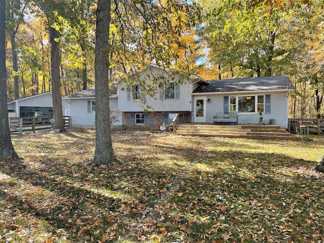 view of front of house with an outbuilding, a garage, and a front lawn