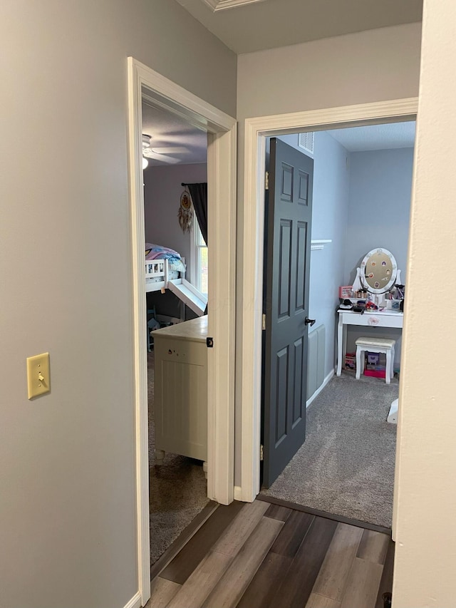 hallway with hardwood / wood-style floors