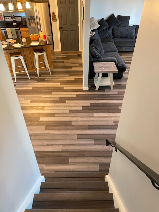 stairs featuring wood-type flooring