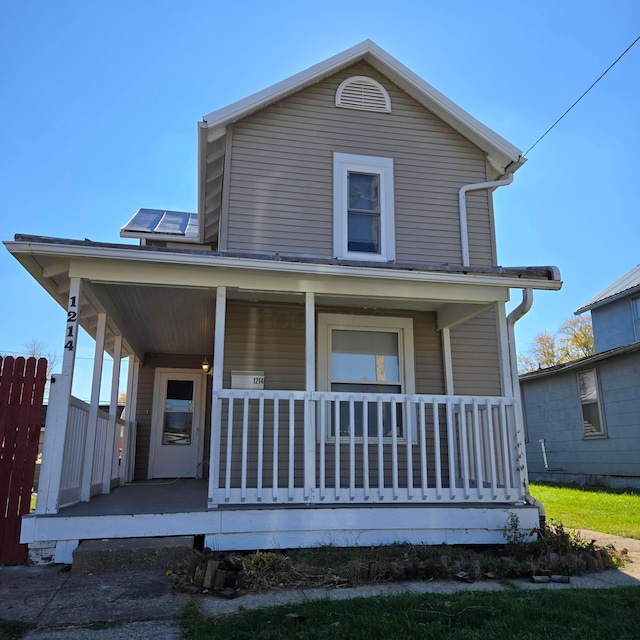 view of front of house with covered porch and solar panels