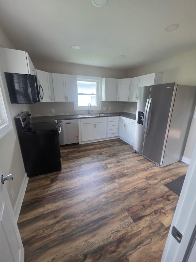 1214 W Mulberry St, Lancaster, OH 43130 - kitchen featuring appliances with stainless steel finishes, white cabinetry, dark countertops, and dark wood finished floors