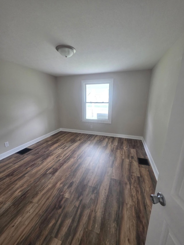 1214 W Mulberry St, Lancaster, OH 43130 - empty room with dark wood-type flooring and baseboards