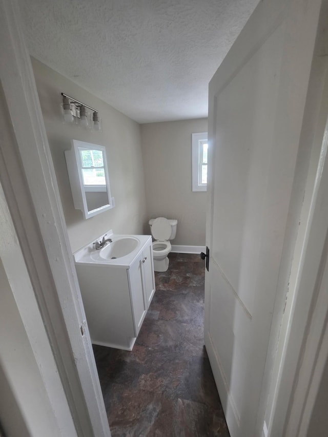 1214 W Mulberry St, Lancaster, OH 43130 - half bathroom with vanity, a textured ceiling, and stone finish flooring