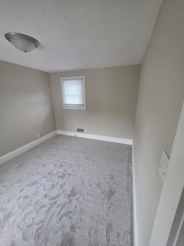 1214 W Mulberry St, Lancaster, OH 43130 - carpeted spare room featuring a textured ceiling and baseboards