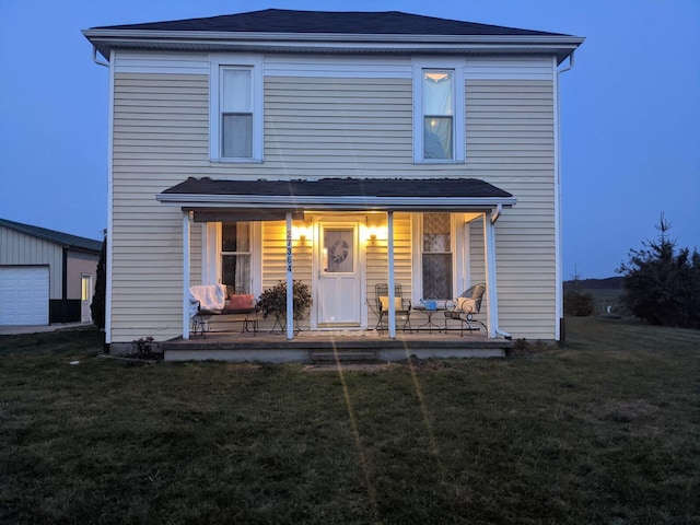 back of property featuring a yard and a porch