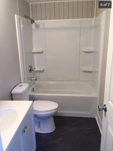 full bathroom featuring tile patterned floors, shower / washtub combination, vanity, and toilet