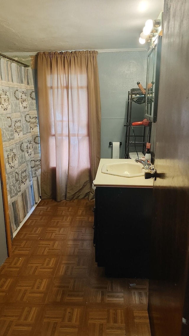 bathroom featuring vanity and parquet flooring