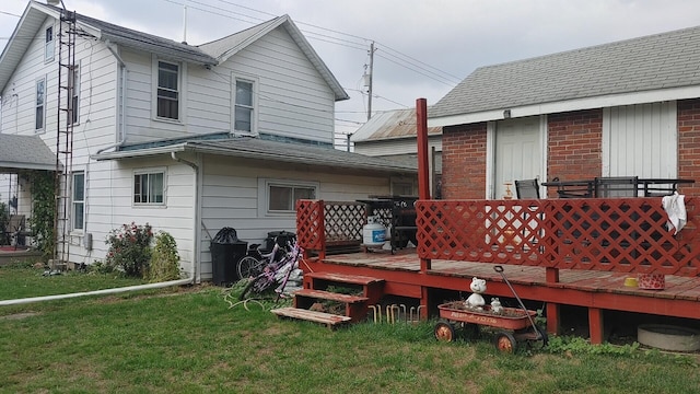 back of property featuring a yard and a wooden deck