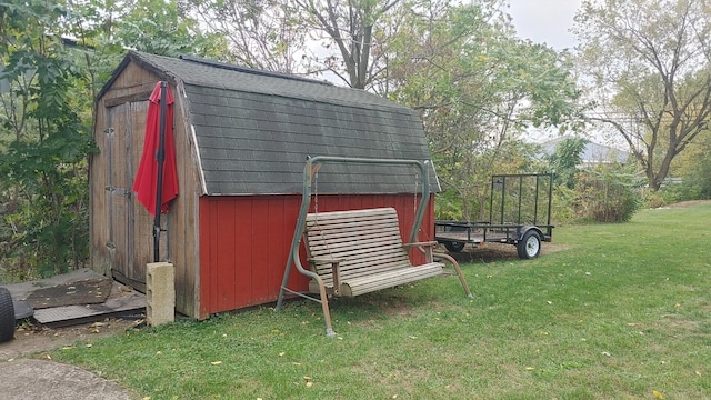 view of outbuilding featuring a yard