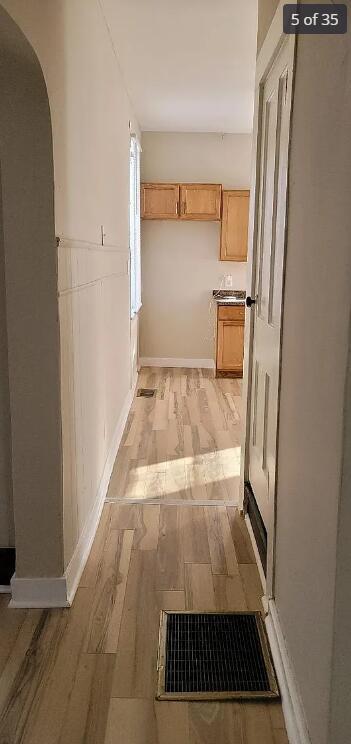 corridor featuring light hardwood / wood-style floors