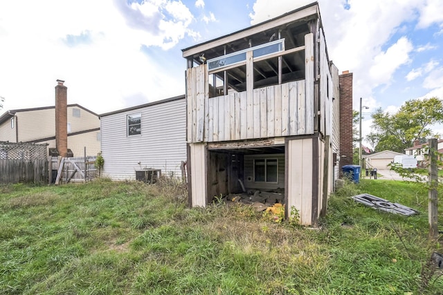 rear view of house featuring cooling unit