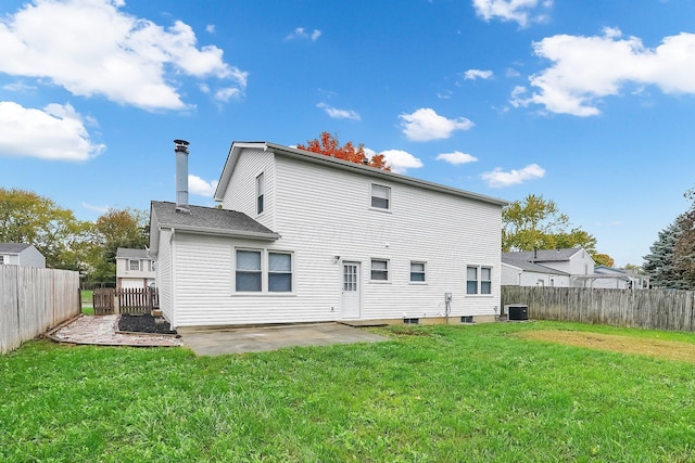 rear view of property featuring a patio, central AC, and a lawn