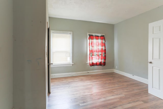 spare room featuring light wood-type flooring