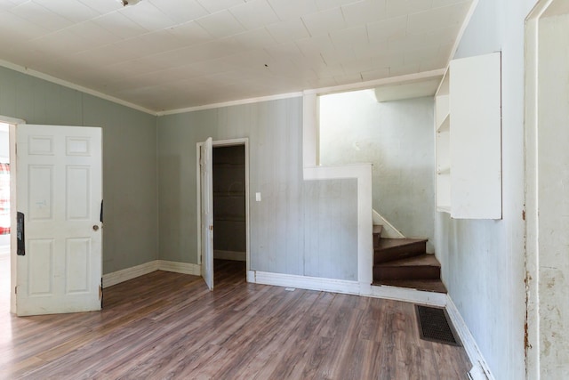 interior space with hardwood / wood-style flooring and crown molding