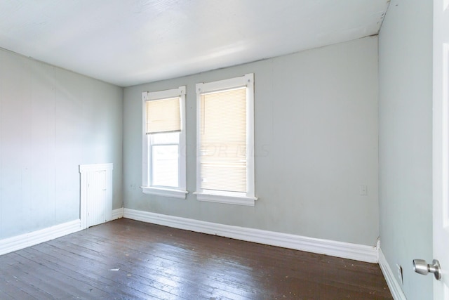 empty room with dark hardwood / wood-style floors