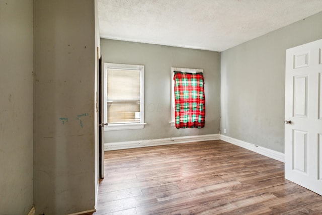 interior space with light hardwood / wood-style flooring and a textured ceiling