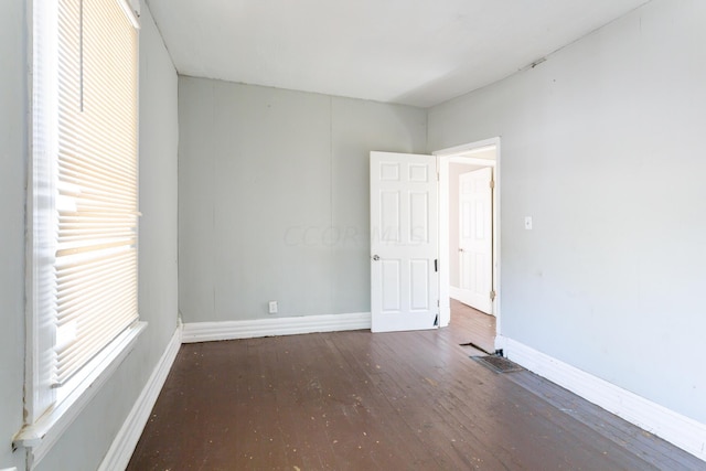 spare room featuring dark wood-type flooring