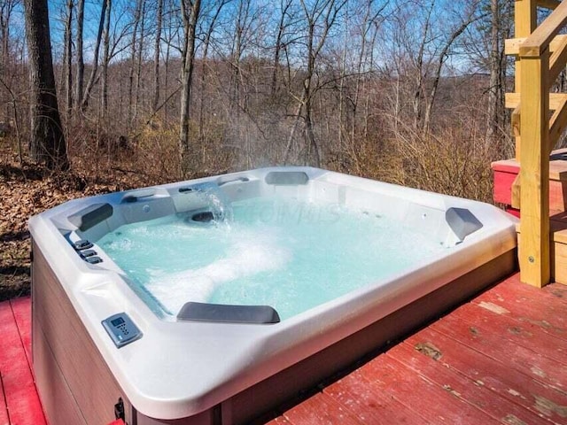 view of swimming pool with a hot tub and a wooden deck