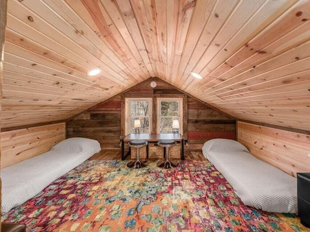 interior space featuring wood ceiling, lofted ceiling, and wooden walls