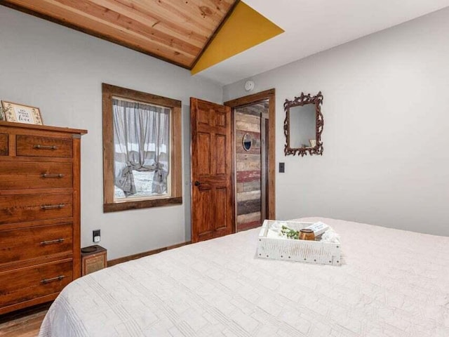 bedroom with hardwood / wood-style floors, wooden ceiling, and lofted ceiling