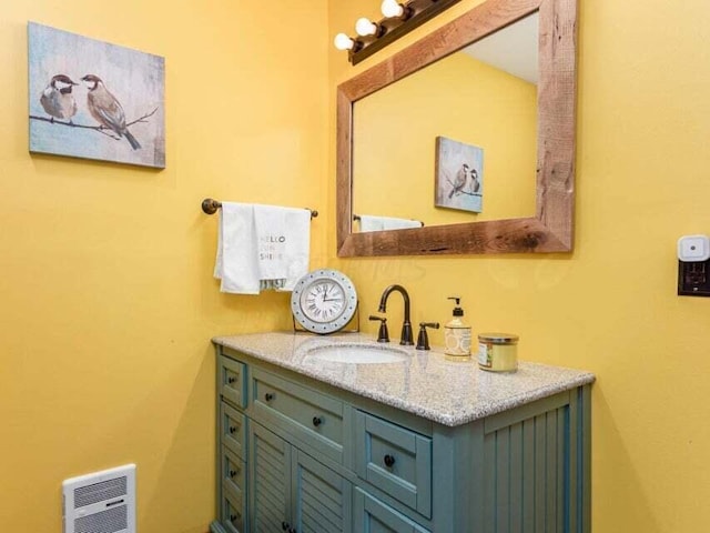 bathroom with vanity and heating unit