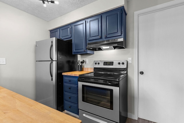 kitchen featuring wooden counters, a textured ceiling, stainless steel appliances, blue cabinetry, and hardwood / wood-style flooring