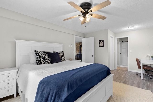 bedroom with a textured ceiling, light hardwood / wood-style floors, and ceiling fan