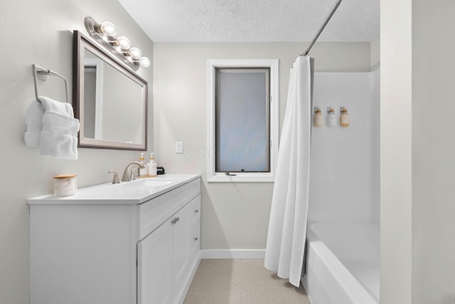 bathroom featuring vanity, shower / bath combination with curtain, and a textured ceiling