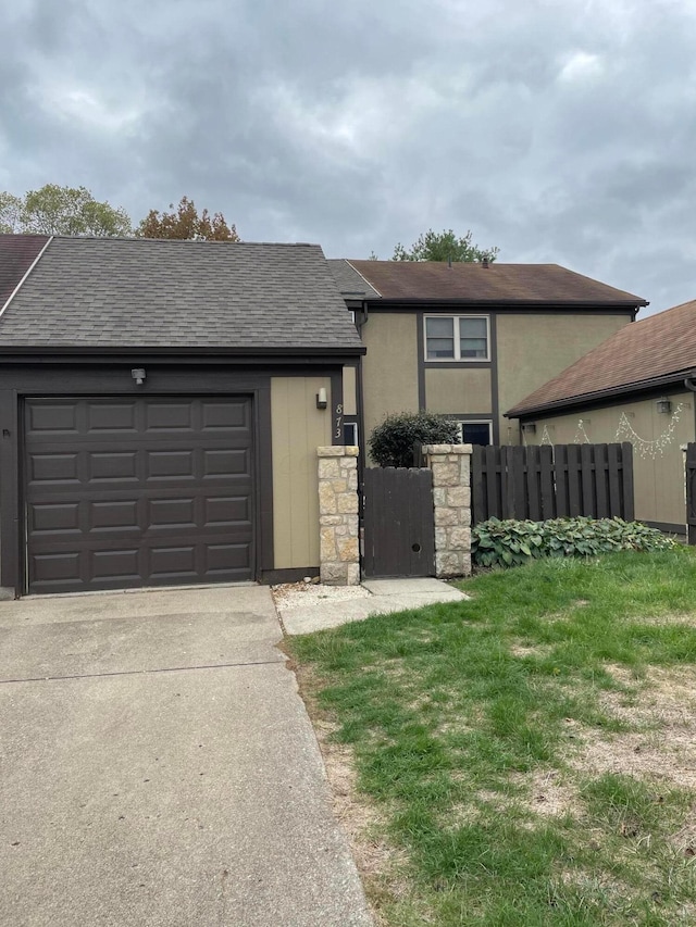 view of front facade with a garage and a front lawn