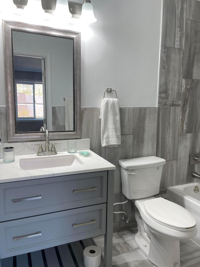 full bathroom with vanity, shower / washtub combination, and toilet