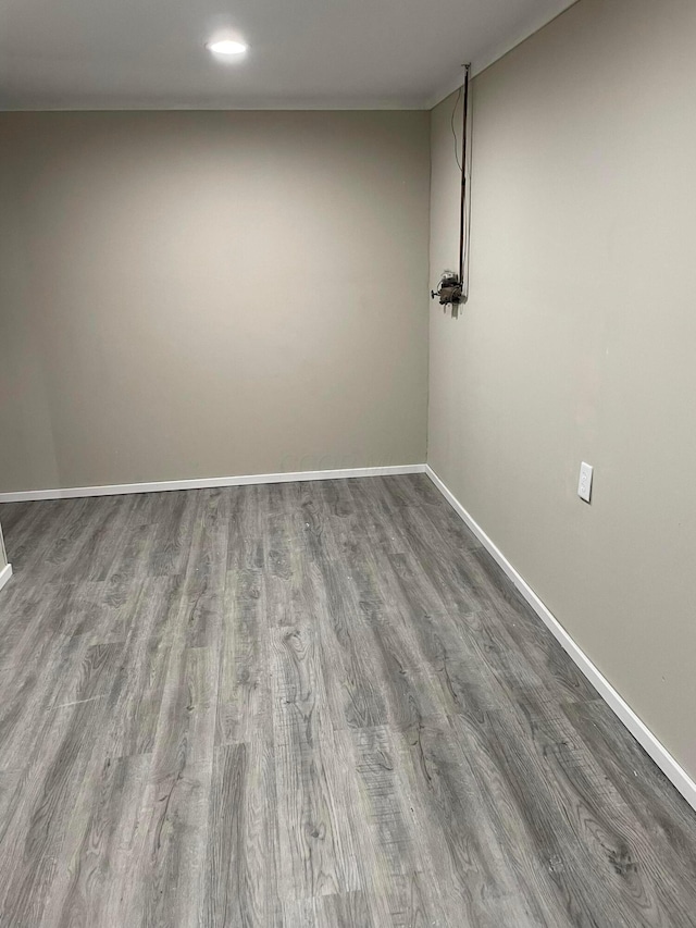 unfurnished room with wood-type flooring