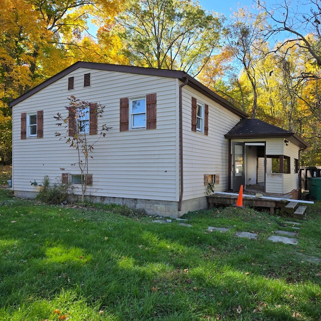 view of side of home featuring a lawn