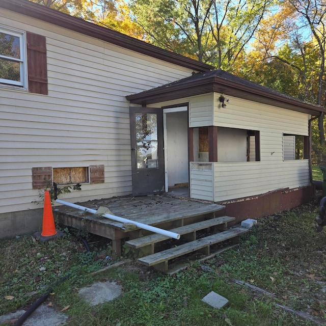 view of exterior entry with a deck