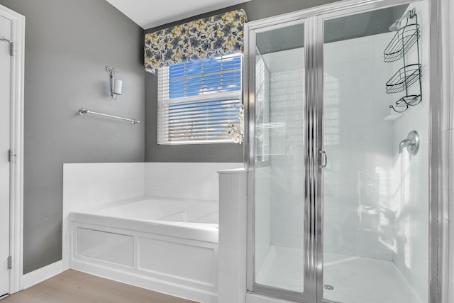 bathroom featuring shower with separate bathtub and hardwood / wood-style flooring