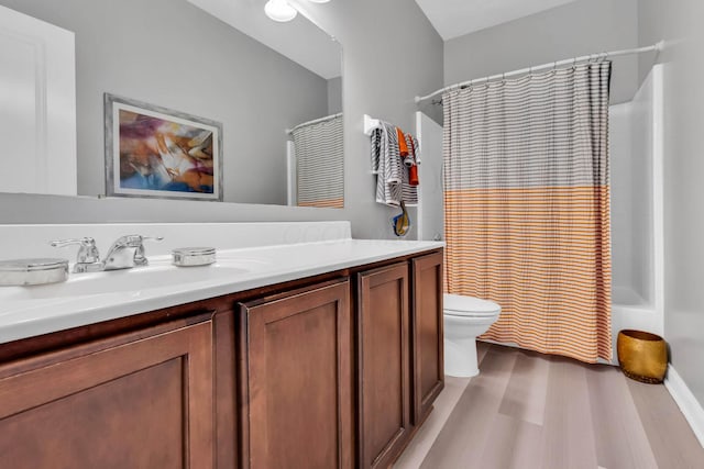 full bathroom featuring wood-type flooring, vanity, toilet, and shower / bathtub combination with curtain