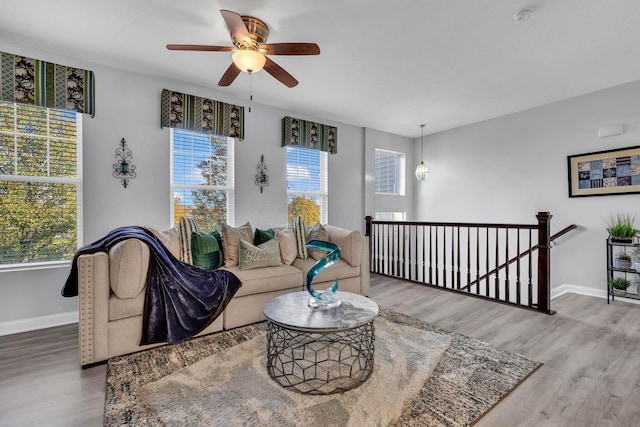 living room with a wealth of natural light, ceiling fan, and hardwood / wood-style flooring