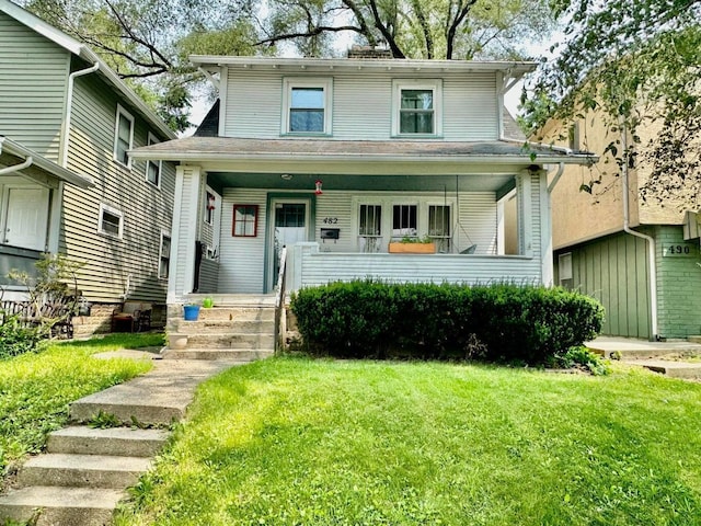 view of front of home with a porch and a front yard