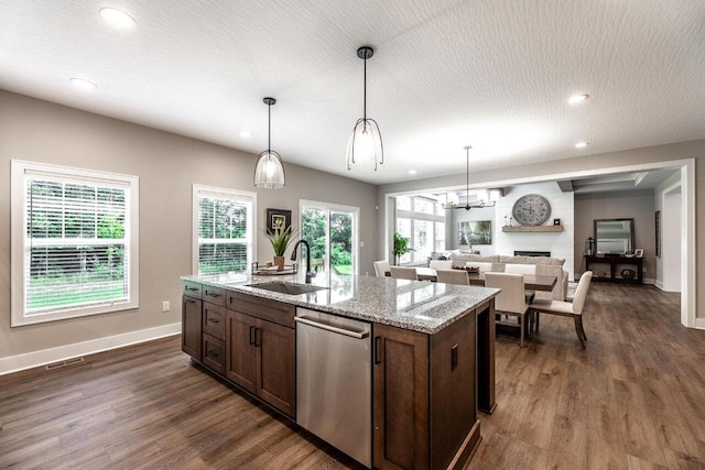 kitchen with stainless steel dishwasher, dark hardwood / wood-style flooring, sink, and hanging light fixtures