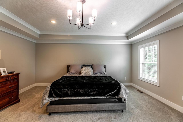 carpeted bedroom featuring an inviting chandelier, a raised ceiling, and ornamental molding