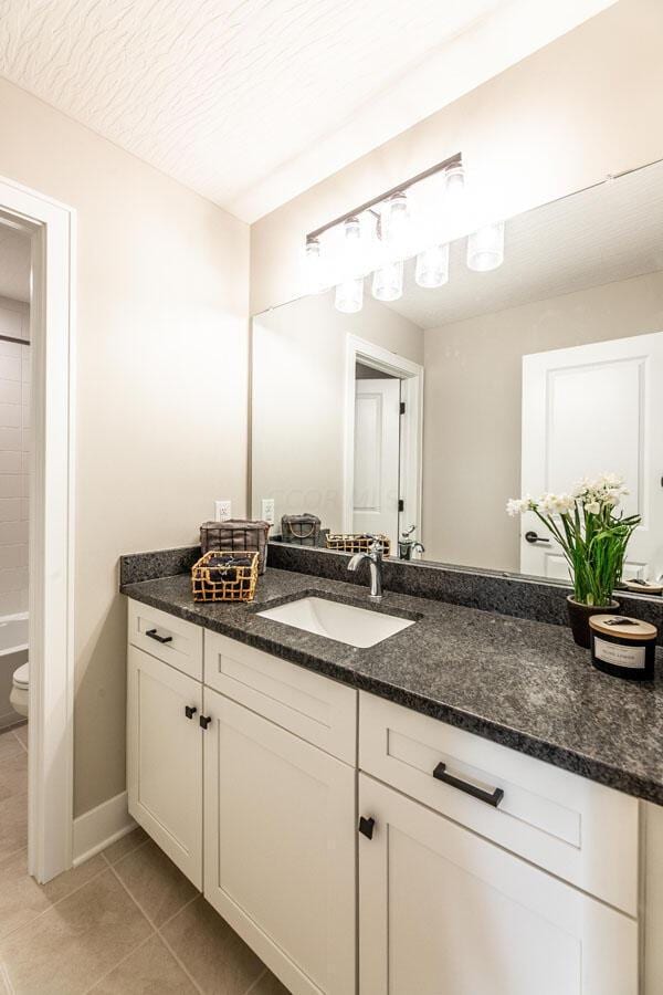 bathroom with tile patterned floors, vanity, and toilet