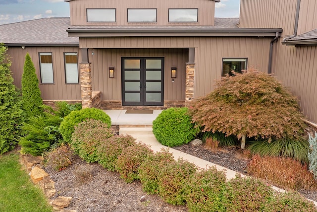 17311 Gambier Rd, Mount Vernon, OH 43050 - view of exterior entry featuring stone siding, roof with shingles, and covered porch