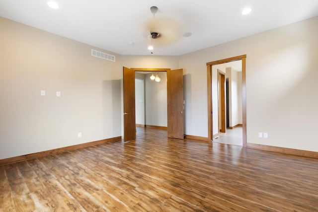 unfurnished room featuring hardwood / wood-style flooring