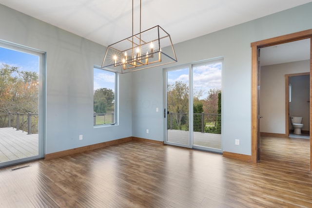 17311 Gambier Rd, Mount Vernon, OH 43050 - empty room featuring wood finished floors and a chandelier