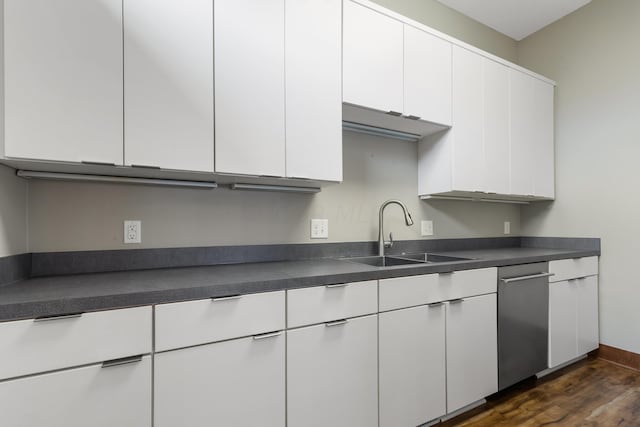 17311 Gambier Rd, Mount Vernon, OH 43050 - kitchen featuring stainless steel dishwasher, dark countertops, white cabinetry, and dark wood finished floors