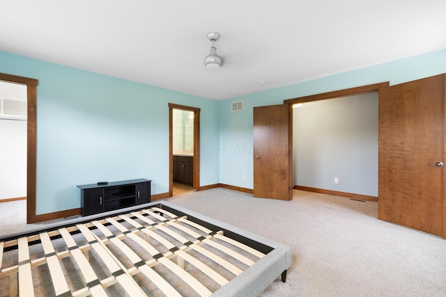 carpeted bedroom featuring ensuite bathroom