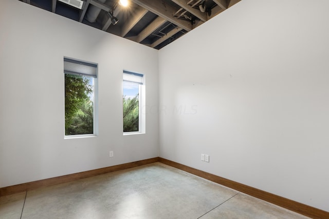 unfurnished room featuring concrete floors