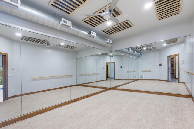 basement featuring ceiling fan and light tile patterned flooring