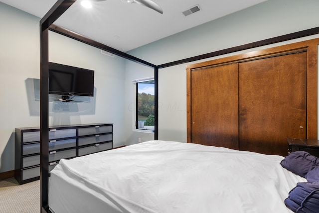 carpeted bedroom featuring a closet and ceiling fan