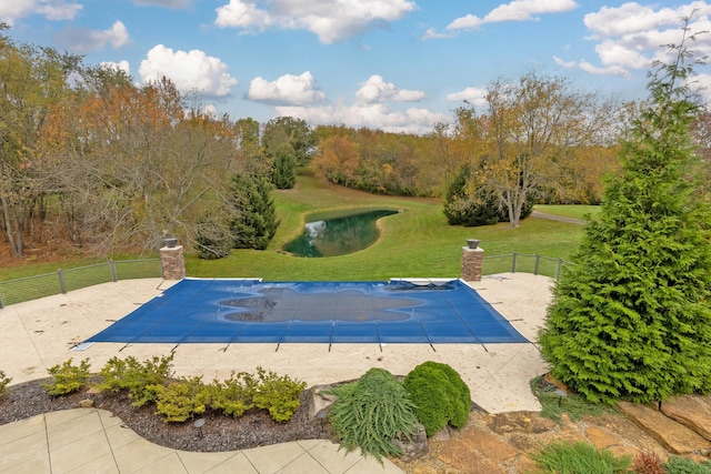 view of swimming pool with a yard and a patio